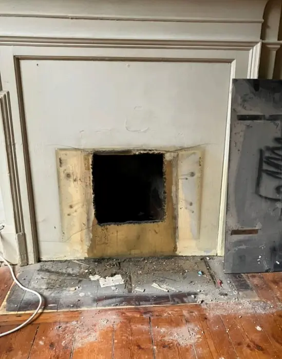 Asbestos insulation board removed from around a fireplace in a London property