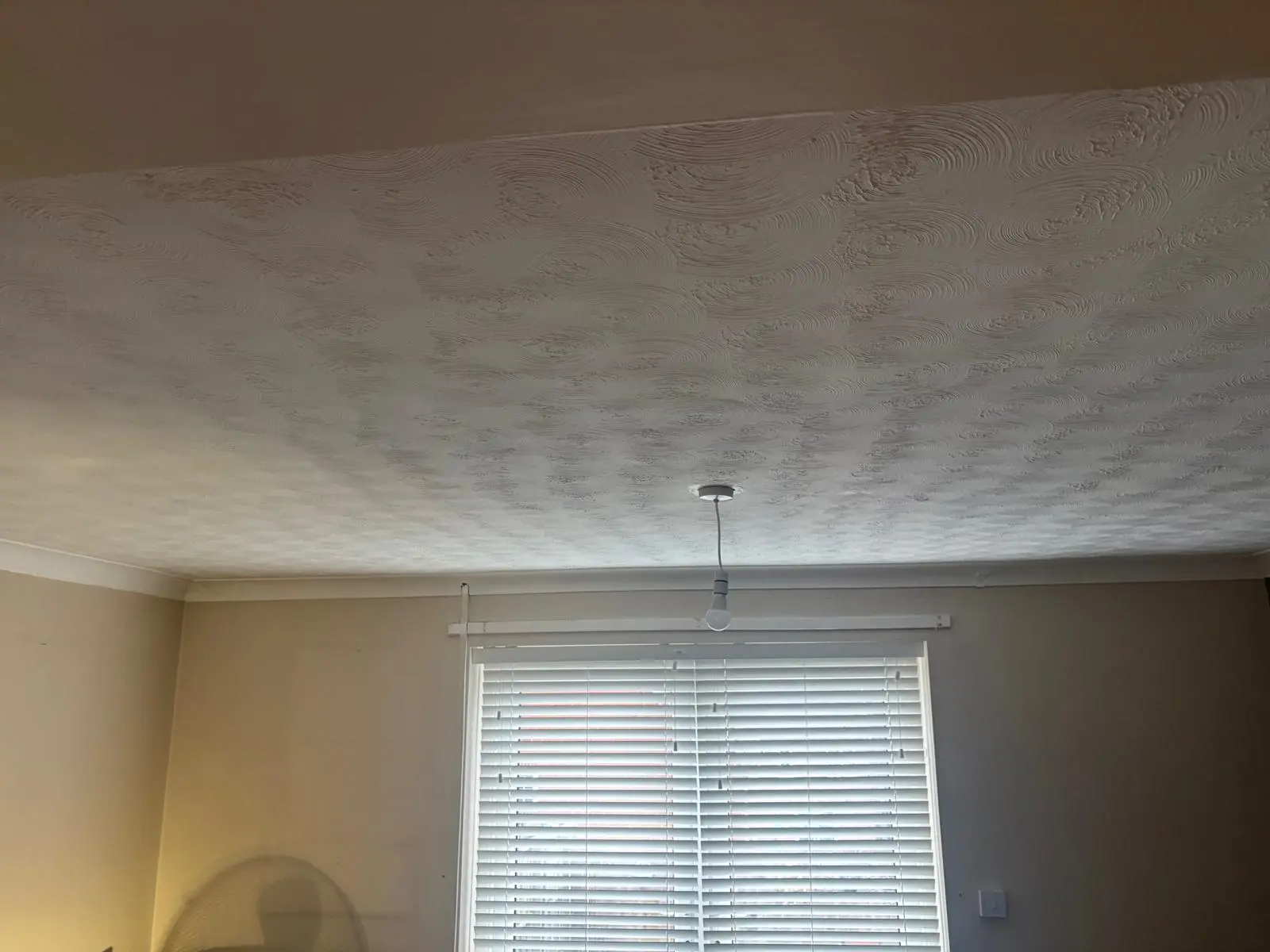 Artex textured bedroom ceiling before asbestos removal in London