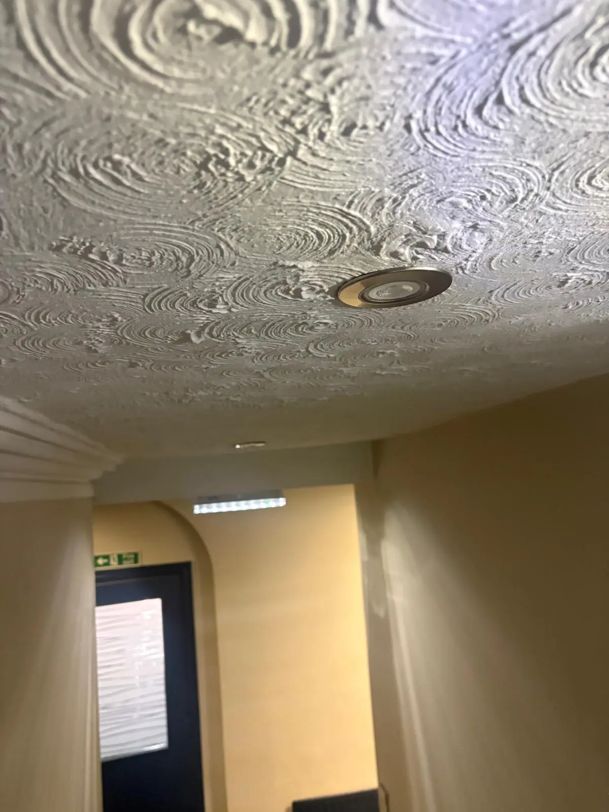 Close-up of an Artex textured coating ceiling before asbestos removal in London