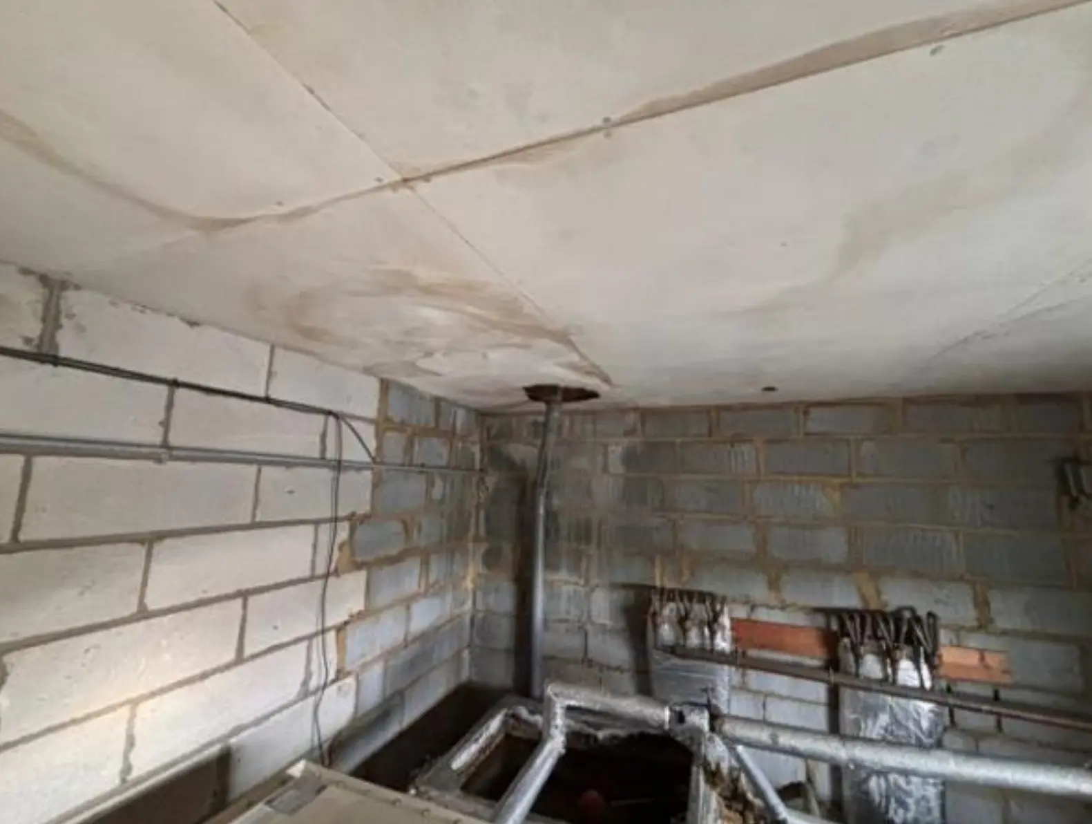 Asbestos AIB removal London — ceiling panels in a property before asbestos insulating board removal